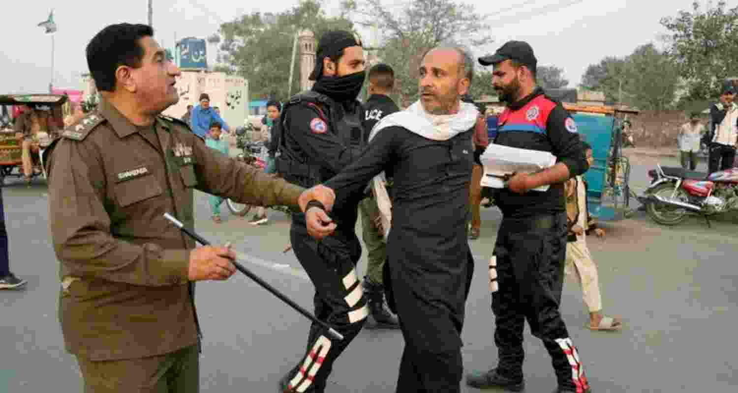 A police officer detains a supporter of former Prime Minister Imran Khan. Image: X