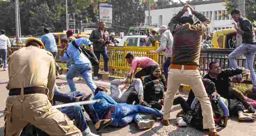 Police personnel lathicharge aspirants during their protest over normalisation of the 70th Bihar Public Service Commission (BPSC) examination, outside BPSC office, in Patna, Friday.