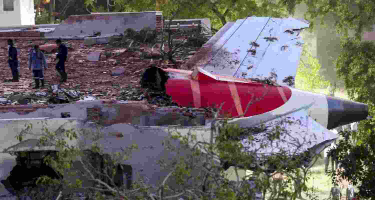 Remains of the Air India plane that crashed moments after taking off from the Ahmedabad airport, lies on a building in Ahmedabad, Thursday.
