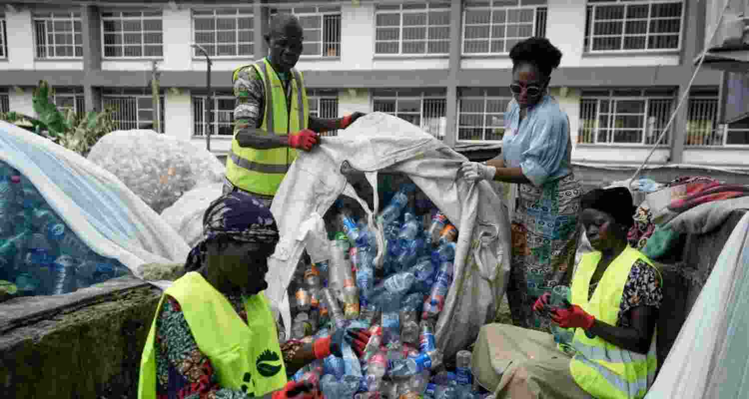 Omoh Alokwe, co-founder of Street Waste Company, sorts out different soft-drink plastic bottles along with workers in Lagos, Nigeria.