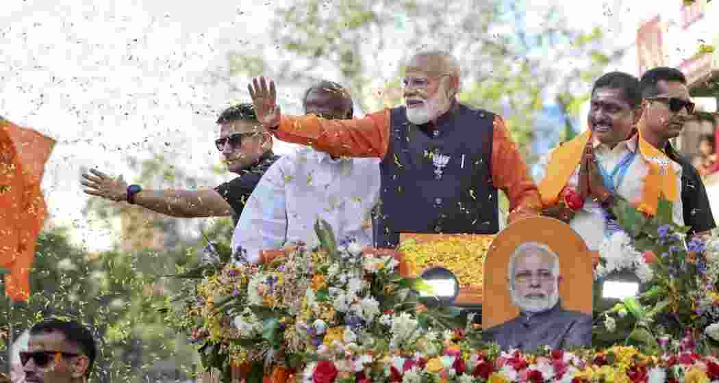 Prime Minister Narendra Modi during a roadshow ahead of the Puducherry Assembly elections, in Puducherry on Friday. Puducherry Chief Minister N Rangasamy and Home Minister Arumugam Namassivayam are also seen. 