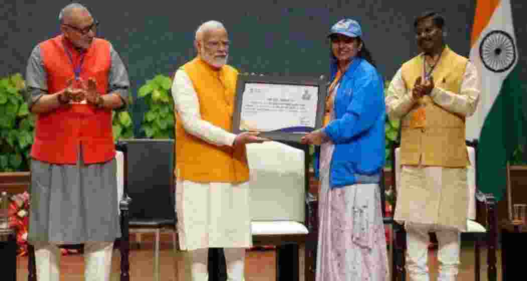Prime Minister Narendra Modi presents certificate of appreciation to a Lakhpati Didi at the Sashakt Nari-Viksit Bharat programme in New Delhi on March 11 this year. Union Minister Arjun Munda and Giriraj Singh are also seen. 