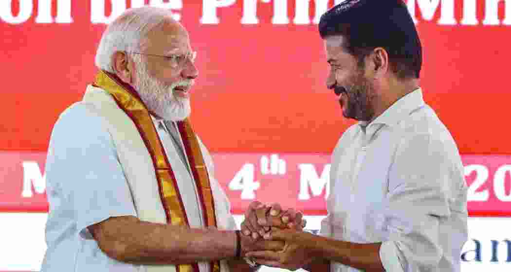  Prime Minister Narendra Modi with Telangana Chief Minister A Revanth Reddy during the launch of development initiatives, in Adilabad, Telangana.