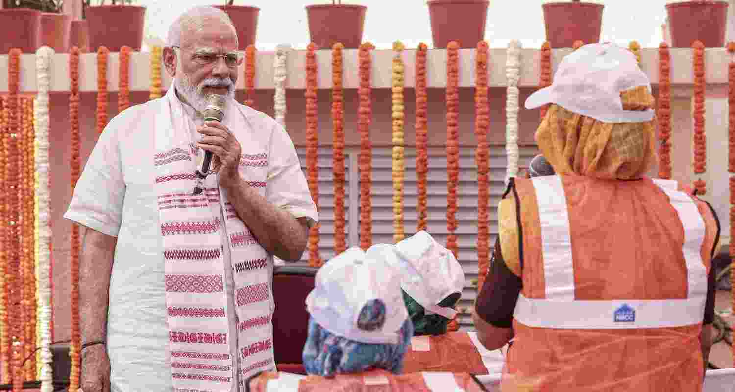 Prime Minister Narendra Modi interacts with women allottees during a visit to GPRA Type-5 quarters, in Sarojini Nagar, New Delhi.