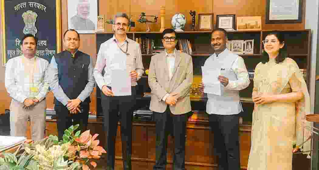 Officials from the Union Education Ministry and the West Bengal government exchange documents after signing the MoU to implement the PM SHRI Schools initiative in the state.