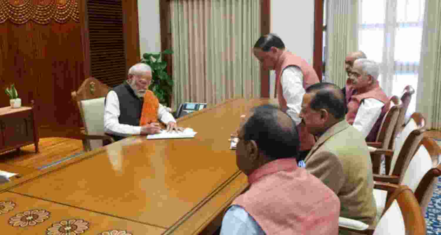 Prime Minister Narendra Modi signs a document - file image.