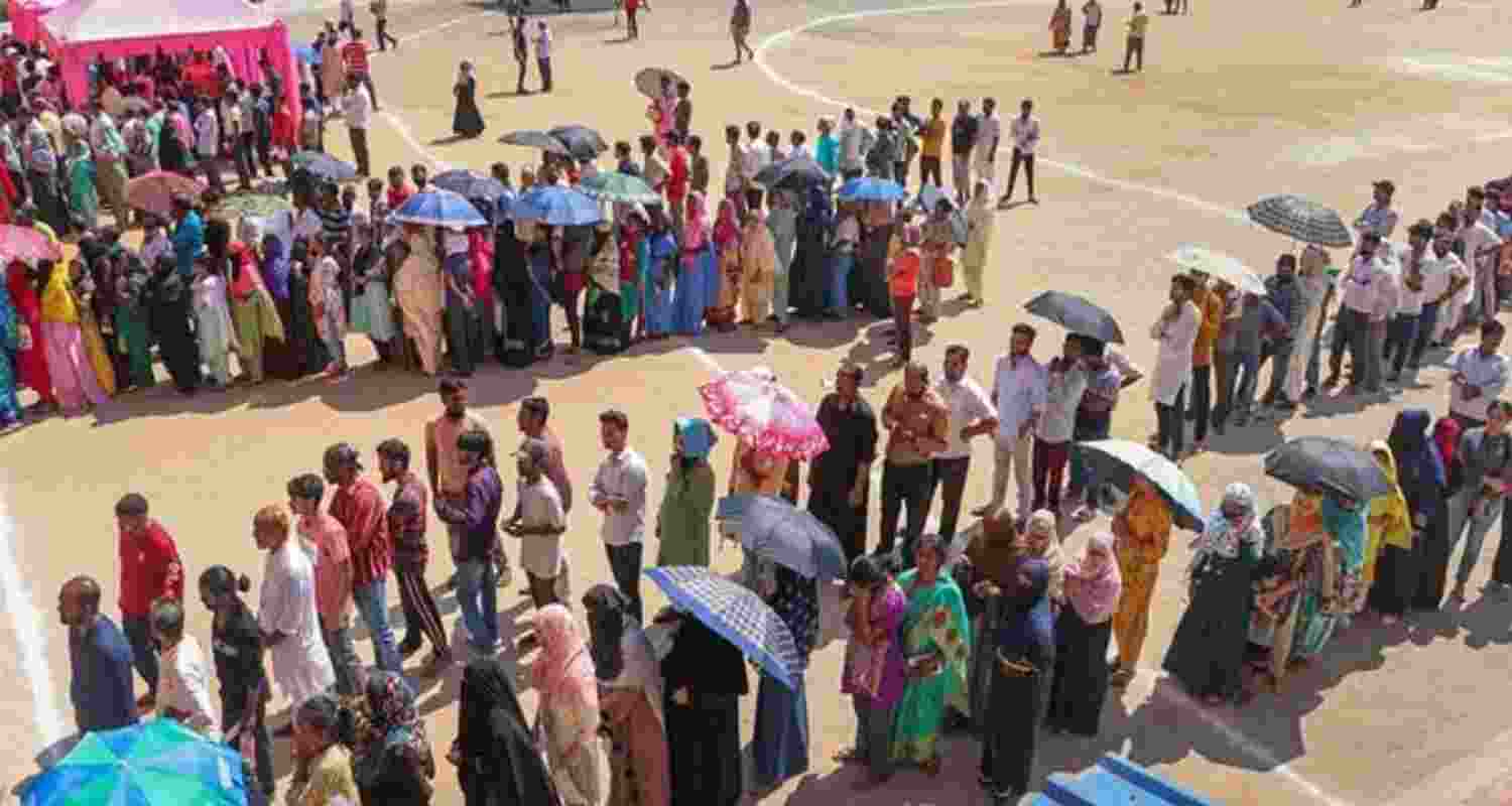 People stand in queue to cast their ballot.