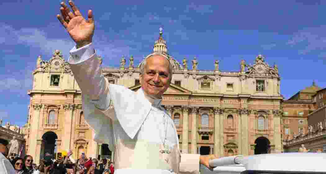 Pope Leo XIV waves to thousands as he rides the popemobile through St. Peter’s Square before his installation ceremony on Sunday.