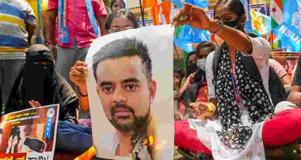 NSUI members burn a poster of JD(S) MP Prajwal Revanna during a protest against his involvement in the alleged sexual abuse case, in Bengaluru. 