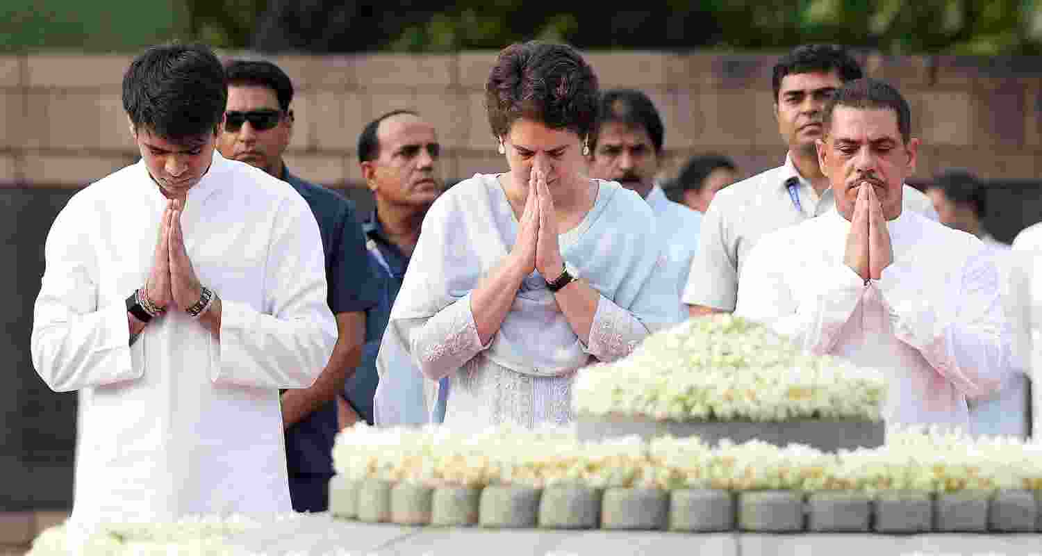 Congress leader Priyanka Gandhi Vadra with husband and businessman Robert Vadra and son Raihan pays tribute to former prime minister Rajiv Gandhi on his birth anniversary, at Veer Bhumi, in New Delhi, Wednesday.