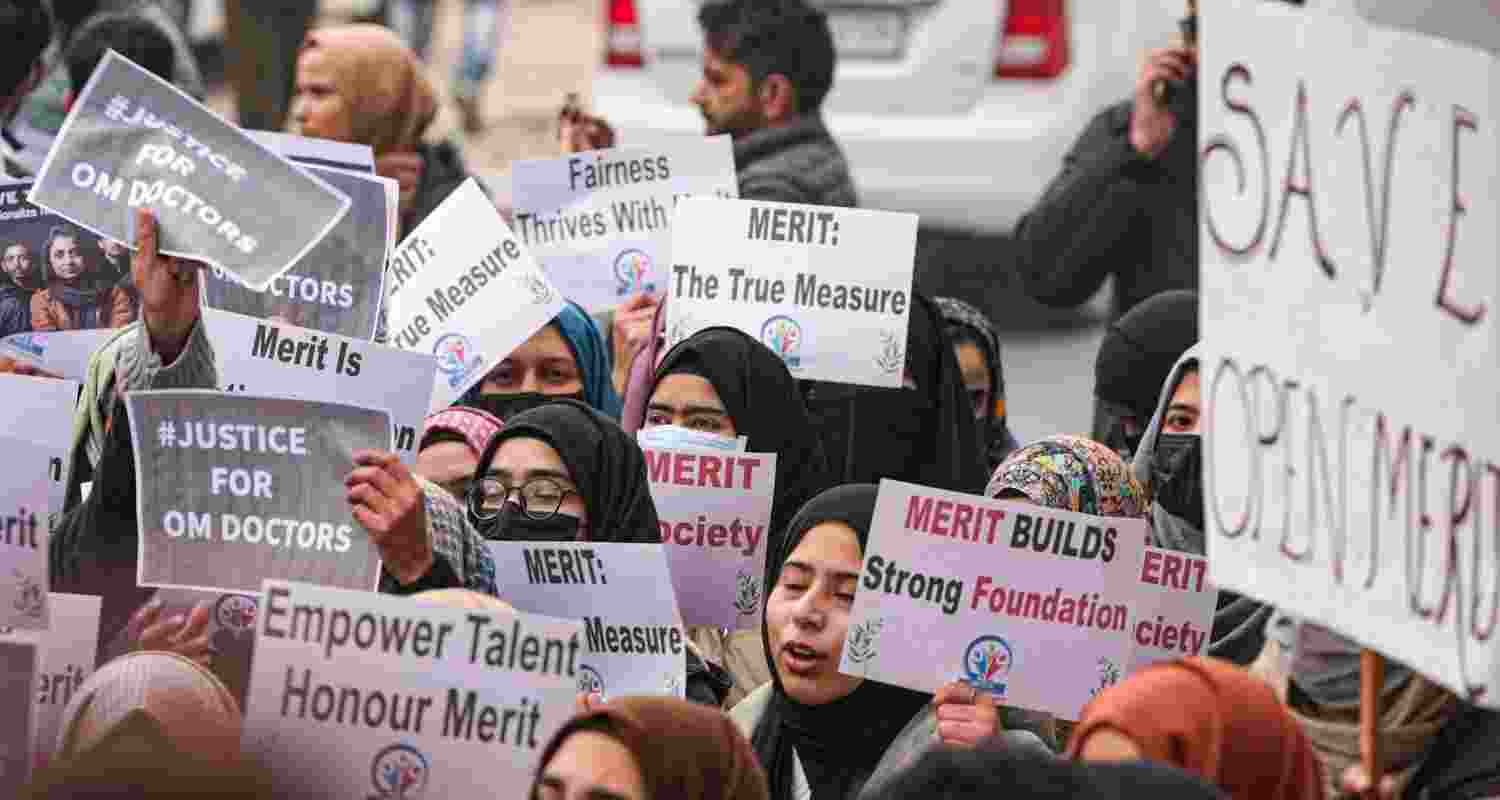 Medical students hold posters during a protest, led by Aga Syed Ruhullah Mehdi (unseen), demanding rationalisation of reservation in Jammu and Kashmir, outside J&K Chief Minister Omar Abdullah’s residence in Srinagar, Monday.