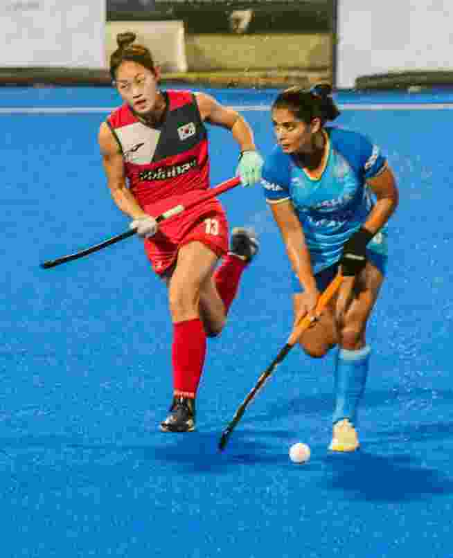 Indian, in blue, and South Korean players vie for the ball during their Women's Asian Champions Trophy 2024 hockey match, at Rajgir, in Nalanda district, Bihar, Tuesday, Nov. 12, 2024.