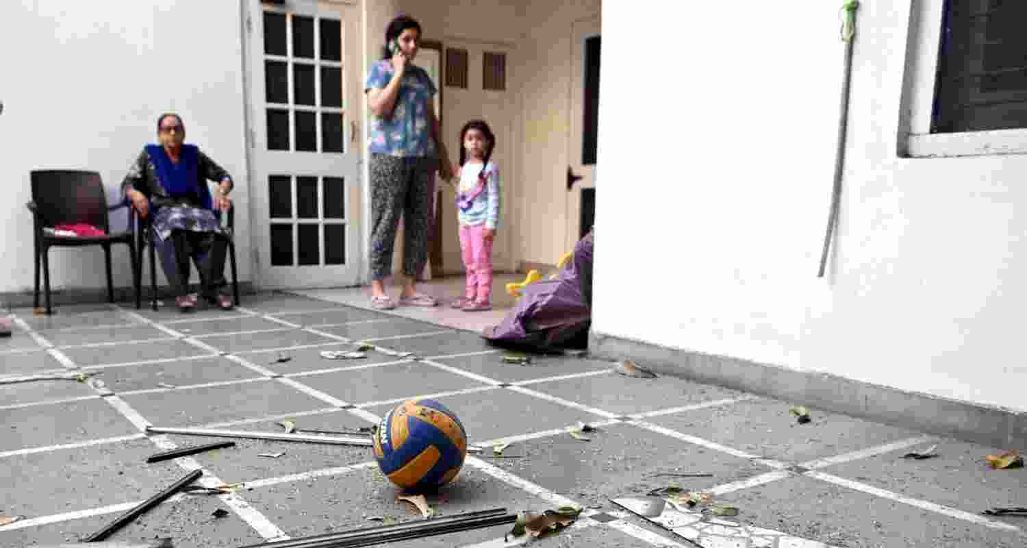 Family members in the house after a "blast" took place outside the residence of BJP leader Manoranjan Kalia, in Punjab's Jalandhar district, Tuesday.