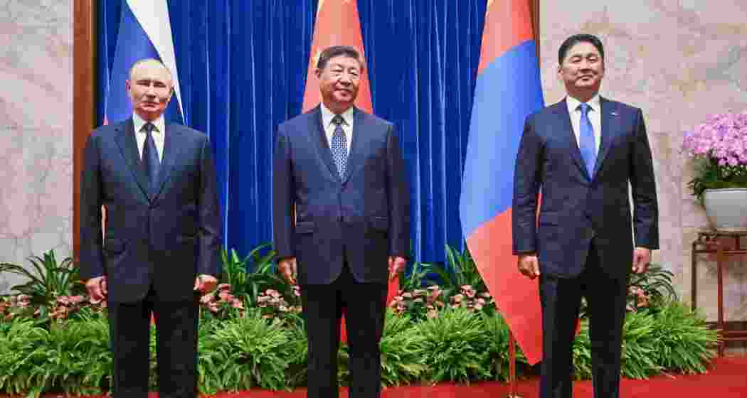 From left, Russian President Vladimir Putin, Chinese President Xi Jinping and Mongolian President Ukhnaagiin Khurelsukh pose for a family photo session ahead of their trilateral meeting in the Fujian Room at the Great Hall of the People in Beijing, China, Tuesday.