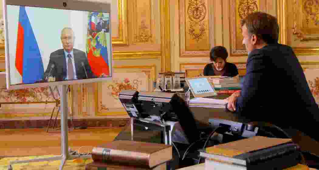 French President Emmanuel Macron talks with Russian President Vladimir Putin during a previous video conference at the Elysee Palace in Paris, France, June 26, 2020. 