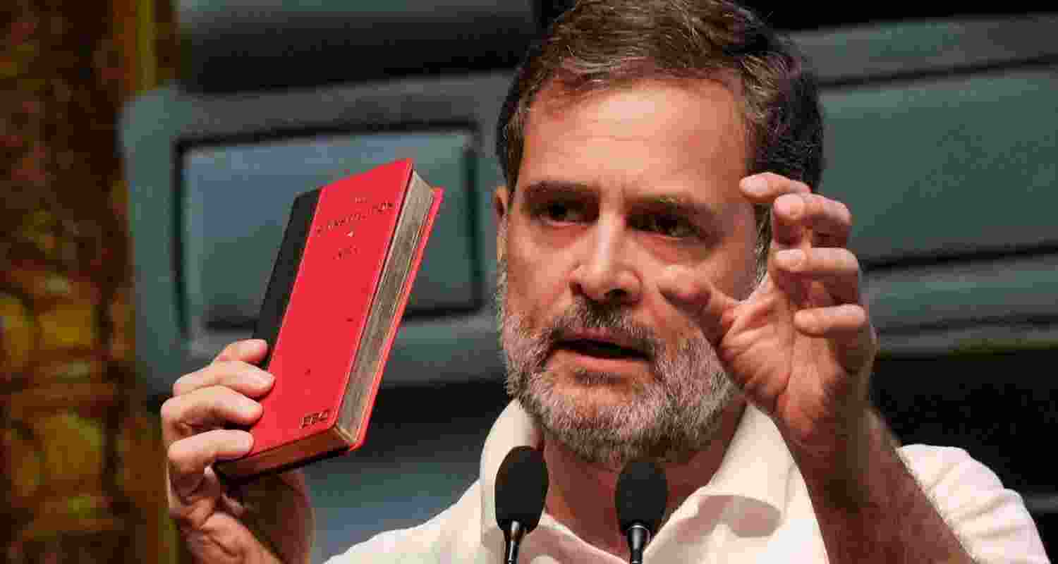 Leader of Opposition Rahul Gandhi holds a copy of the Constitution of India during his address at the Talkatora stadium, New Delhi.