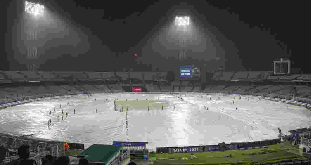 Ground staff covers the field after rain stopped play during an Indian Premier League (IPL) 2025 T20 cricket match between Kolkata Knight Riders and Punjab Kings, at the Eden Gardens stadium, in Kolkata, West Bengal, Saturday, April 26, 2025. 