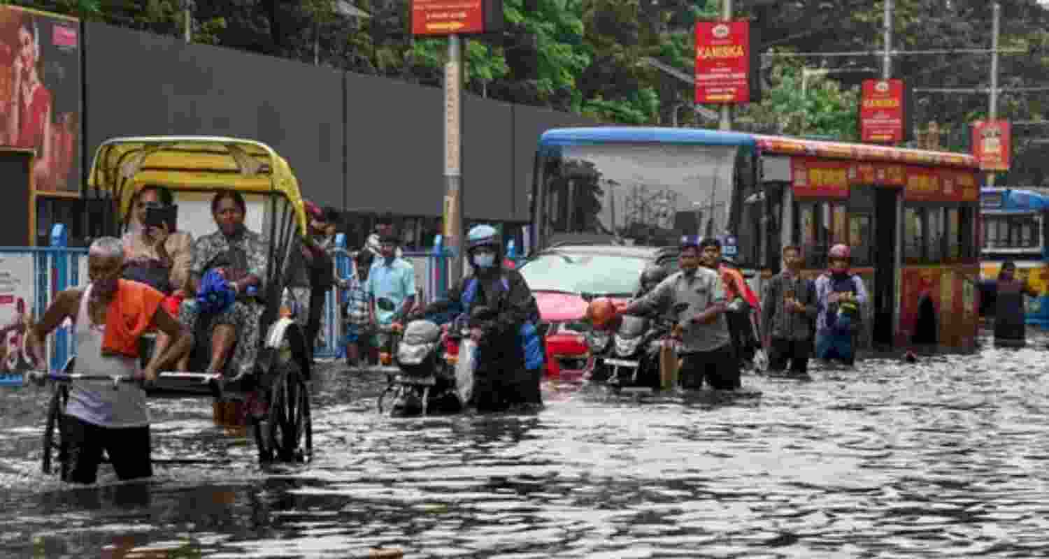 Heavy rainfall disrupts daily life of people in Kolkata, with water entering houses and residential complexes on Friday. Heavy rainfall disrupts daily life of people in Kolkata, with water entering houses and residential complexes on Friday.