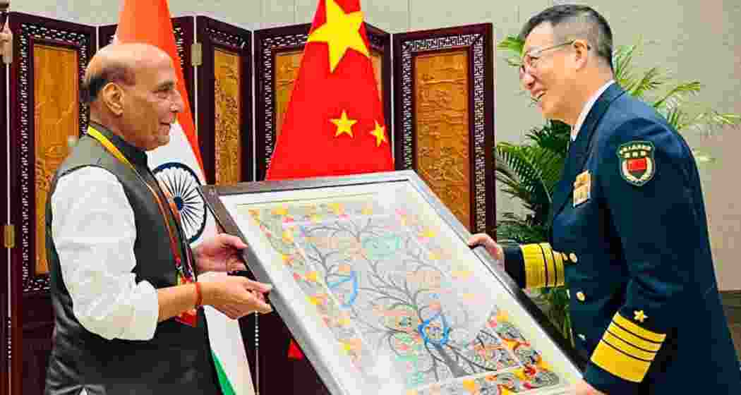 Defence Minister Rajnath Singh presents a Madhubani painting from Bihar to Chinese Defence Minister Admiral Don Jun during a meeting in Qingdao on the sidelines of the SCO conclave on Friday.