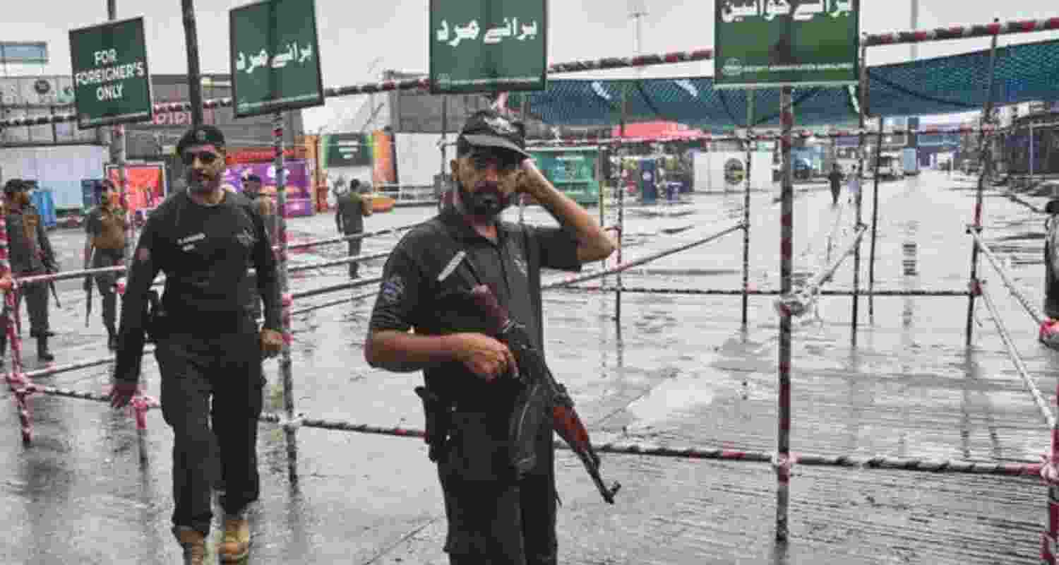 Police officers stand guard at an entry point to Rawalpindi Cricket Stadium following the crash of a suspected Indian drone in the parking area on Thursday.