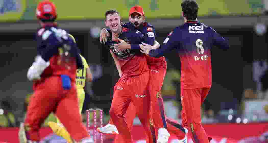  RCB players celebrate the fall of a wicket at Chepauk stadium in Chennai on Friday.
