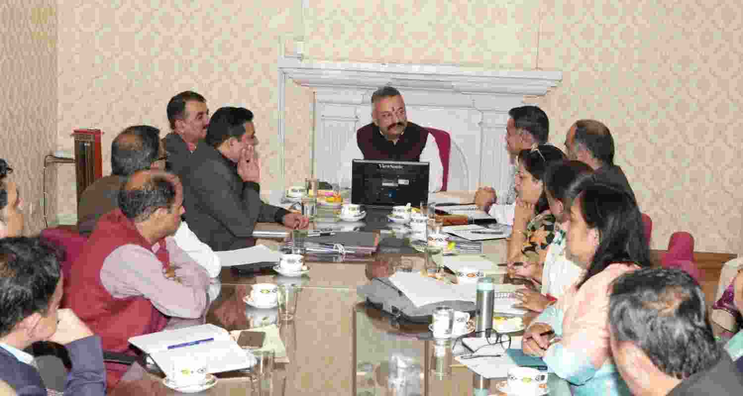 Education Minister presides over a meeting on curriculum revision.