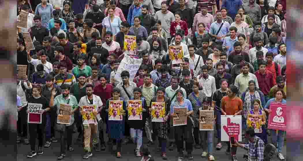 Doctors raise slogans during a protest rally over the recent alleged rape and murder of a trainee doctor at the RG Kar Medical College and Hospital, in Kolkata.