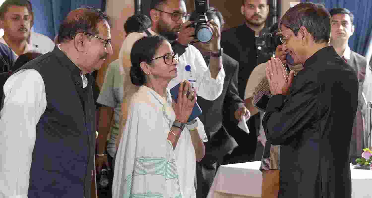 West Bengal Chief Minister Mamata Banerjee, centre, greets newly appointed Governor RN Ravi, right, during his swearing-in ceremony, at Lok Bhavan in Kolkata, West Bengal, Thursday, March 12, 2026.