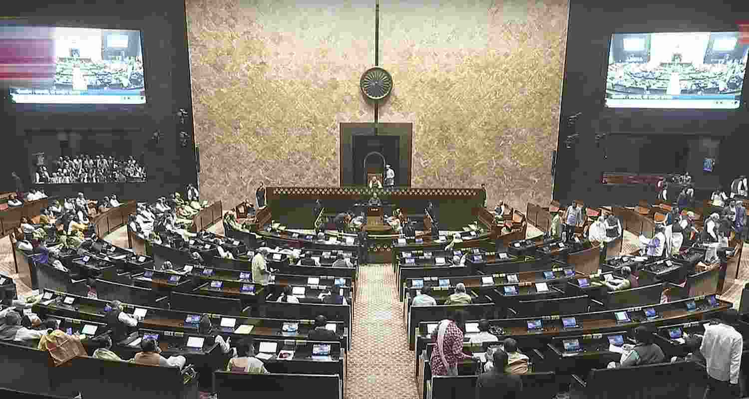 Opposition members walk out of the Rajya Sabha during the Budget session of Parliament, in New Delhi, Thursday.