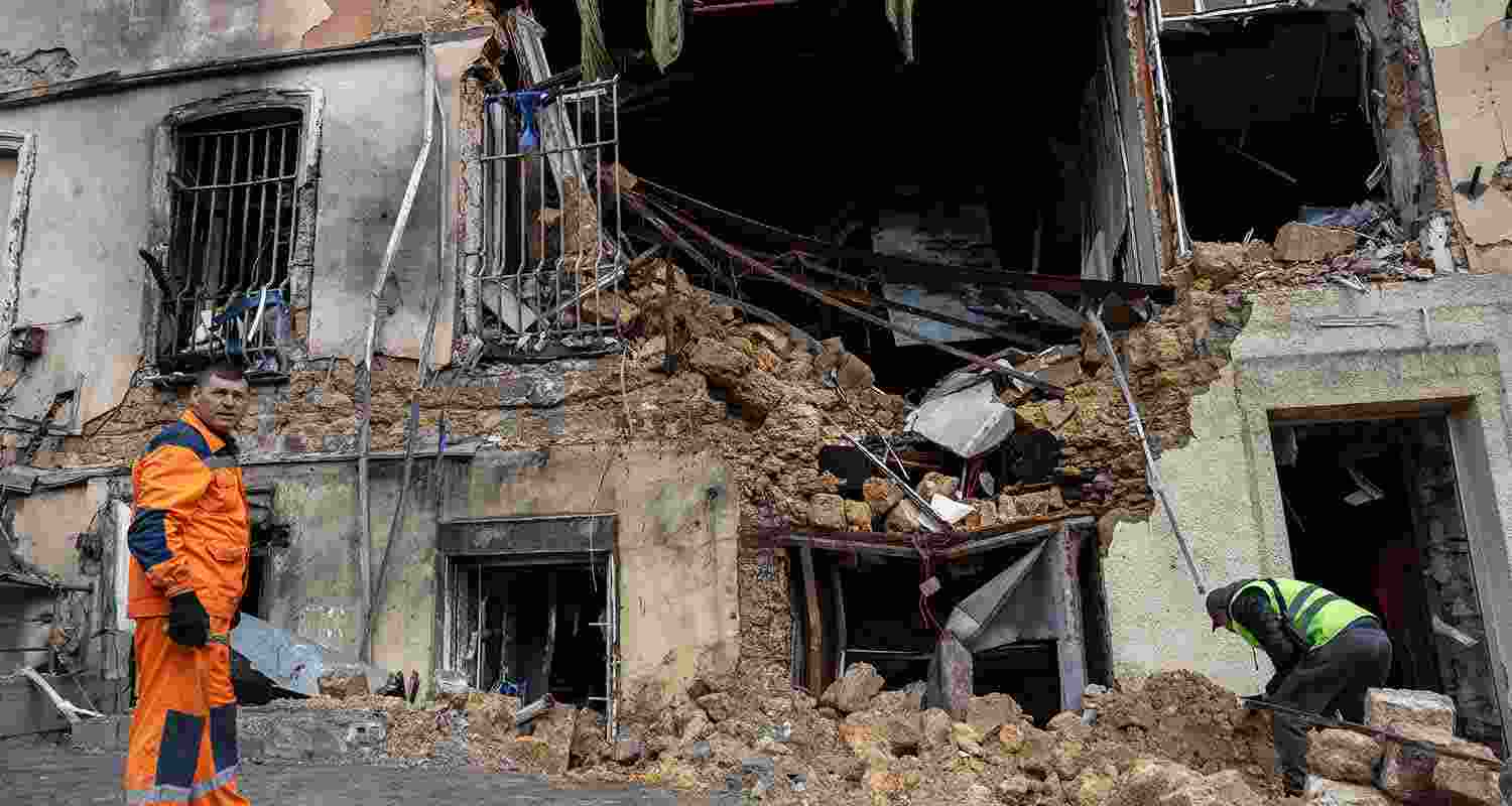 Municipal workers clear the rubble of residential building damaged after a Russian drone strike in Odesa, Ukraine, on Thursday.