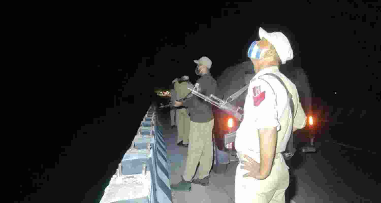 Cops observing movement of drone in Ghagwal area of Samba on Monday night.