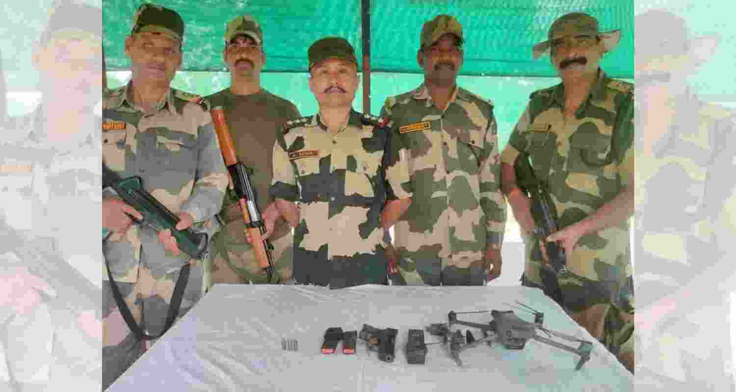 BSF troops with the heroin, pistols, ammunition and drone seized from the smugglers.