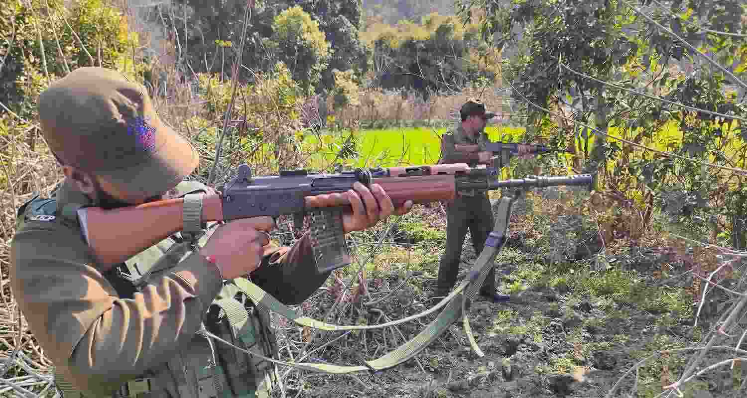 Security personnel during a search operation near LoC forest area, in Akhnoor sector in Jammu, Saturday. 