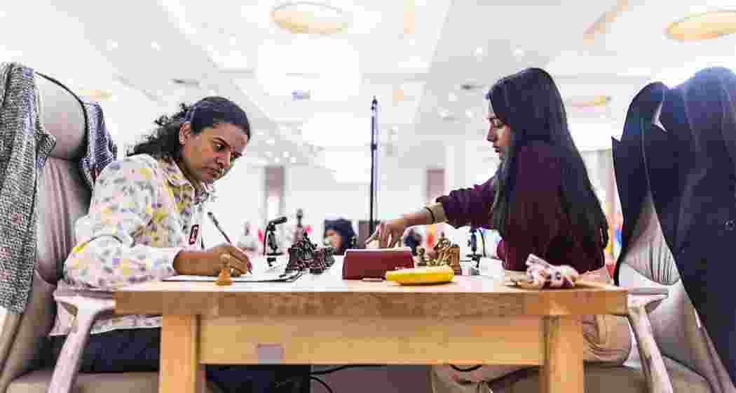 Divya Deshmukh and Koneru Humpy during Game 1 of the Women’s World Cup final in Germany on Saturday, which ended in a draw after a tense 41-move tactical showdown.