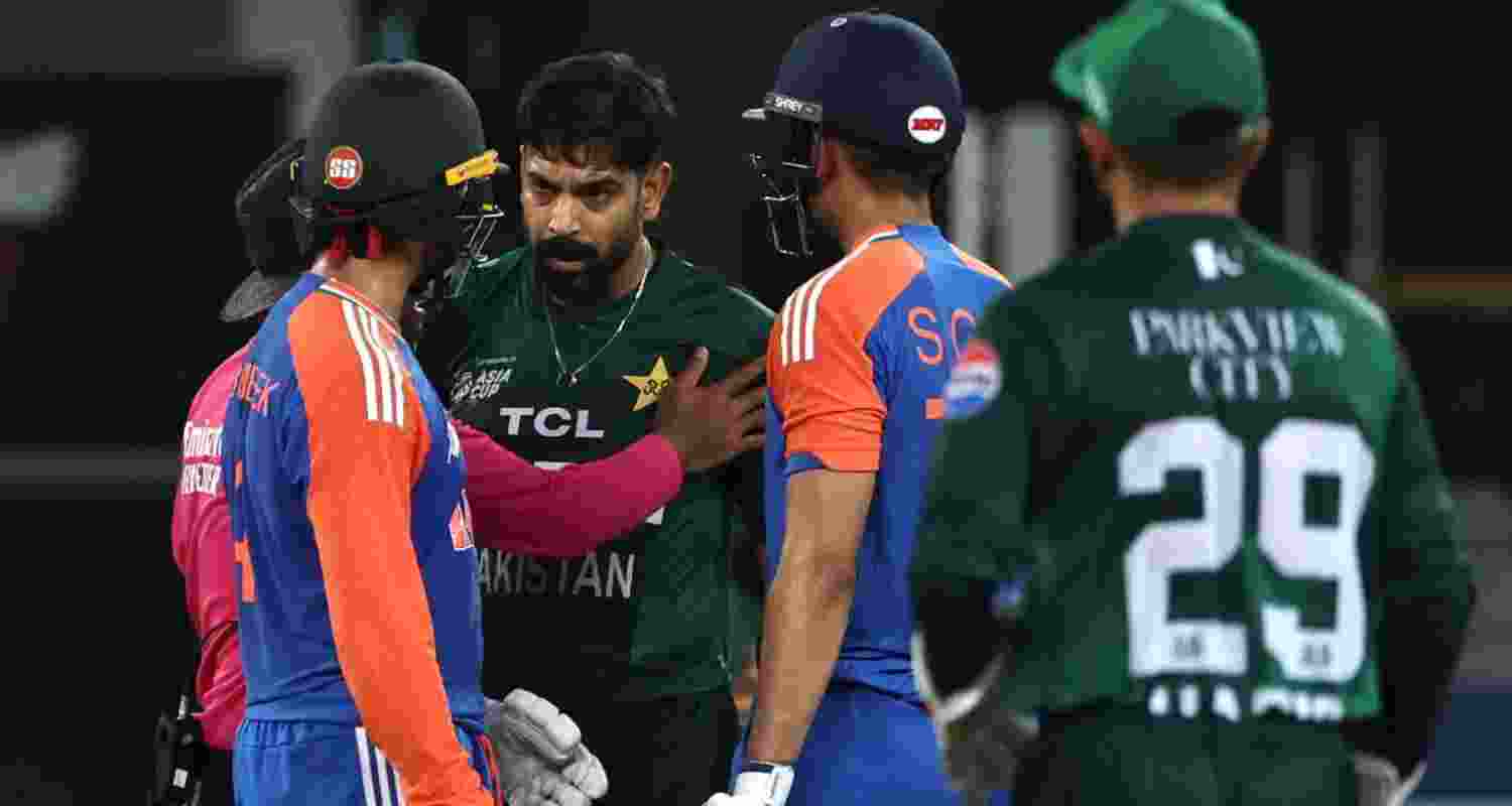 A file photograph of the umpire trying to pacify Pakistan pacer Haris Rauf and the Indian openers after they had a heated exchange during the match last Sunday.