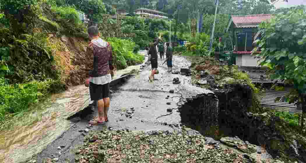 Section of a road damaged due to landslides triggered by incessant rainfall, at Mangan in North Sikkim.