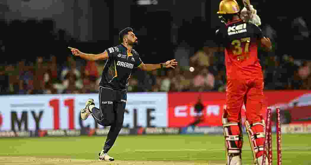 Mohammed Siraj celebrates after claiming a wicket during Gujarat Titans' IPL clash against Royal Challengers Bengaluru. 