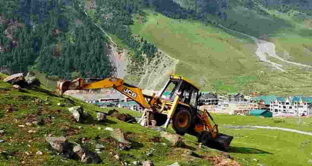 A backhoe loader clearing a property in Sonamarg. File photo.