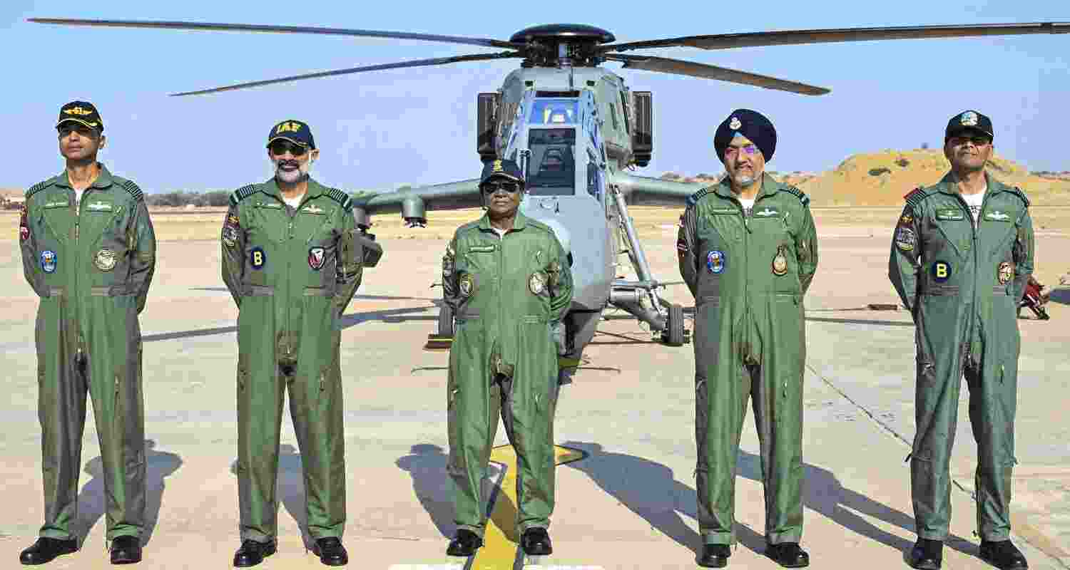 President Droupadi Murmu, centre, with Chief of the Air staff Air Chief Marshal AP Singh, second left, and others, stands in front of the indigenous Light Combat Helicopter 'Prachand' before undertaking a sortie at Air Force Station, in Jaisalmer, Rajasthan. 