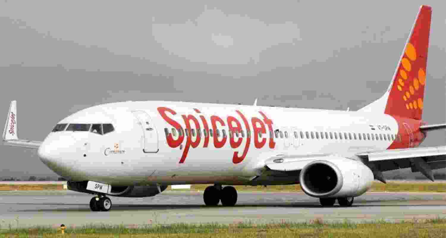 A SpiceJet aircraft seen flying after taking off from the runway at Indira Gandhi International Airport, in New Delhi.