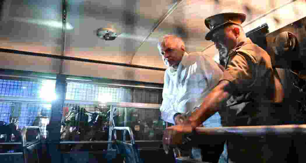 Ex-Sri Lanka president Wickremesinghe is seen inside a police van en route to Colombo Fort magistrate’s court on Saturday, following his arrest over alleged misuse of state funds.