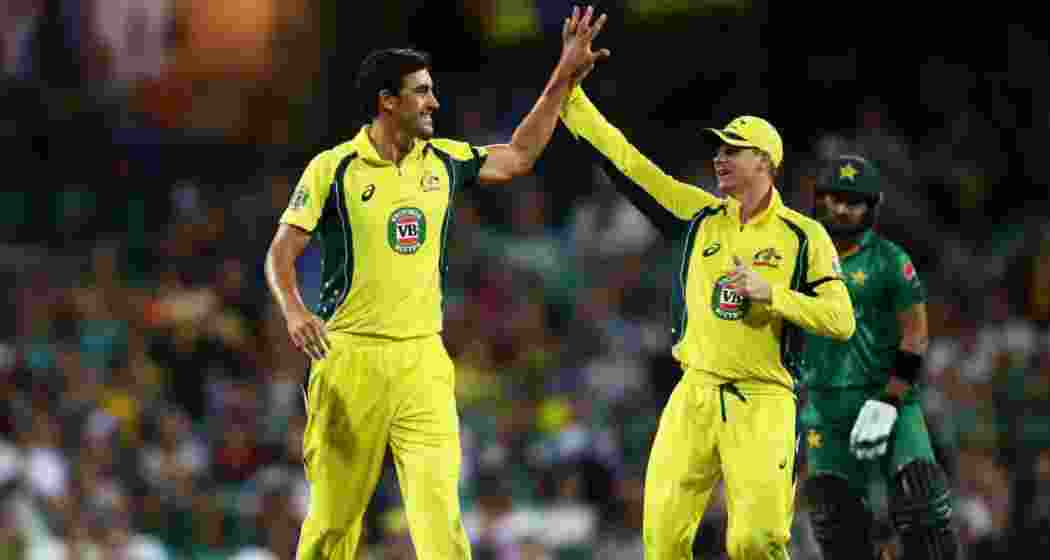 Mitchell Starc and Steve Smith celebrate a wicket during a match against Pakistan.