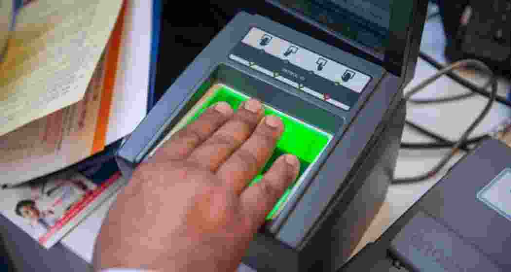 A customer undergoing Aadhaar verification at a service centre.
