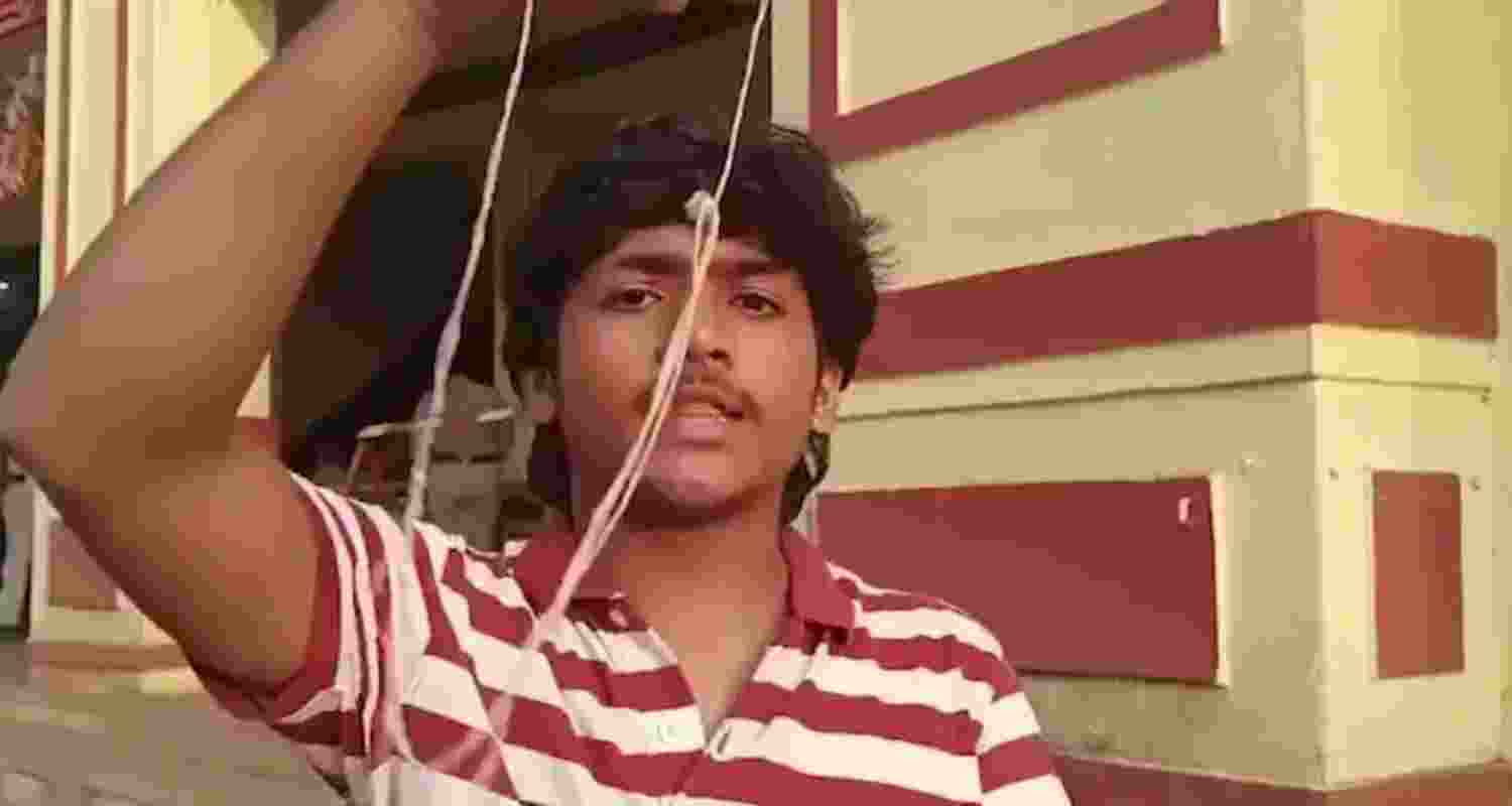 Student Partha Rao showing his janivara after he picked it up from the dustbin.