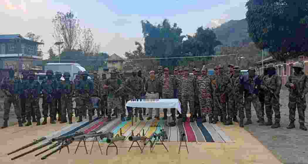 Security personnel stand guard with surrendered arms at the Commando unit in Lamlai, police stations in Porompat and Heingang, and the 7th Manipur Rifles battalion in Imphal East.