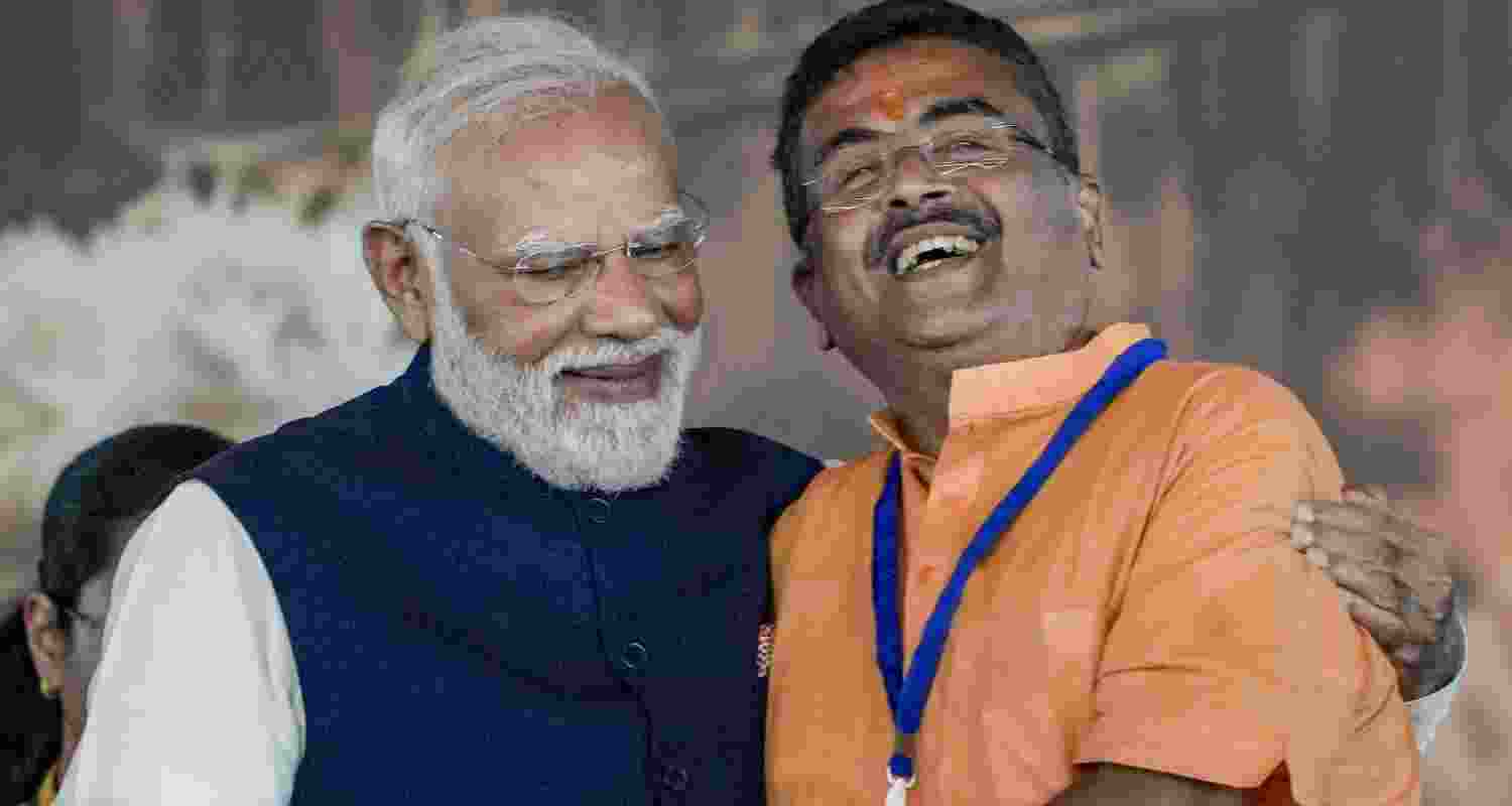 Prime Minister Narendra Modi with West Bengal Chief Minister-elect Suvendu Adhikari during the latters' oath-taking ceremony as party forms government in the state for the first time, at Brigade Parade Ground in Kolkata, West Bengal, Saturday.