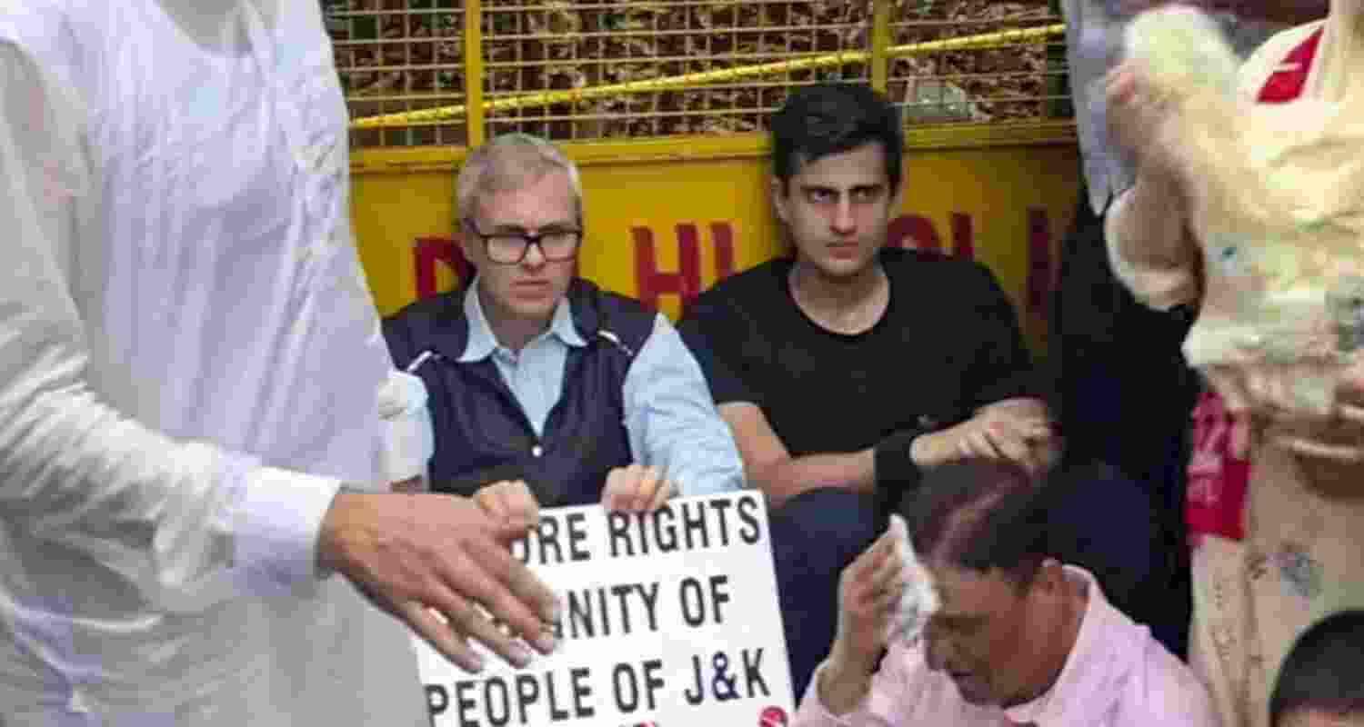 Jammu and Kashmir Chief Minister Omar Abdullah sitting on a road during a protest march demanding the restoration of statehood in Jammu and Kashmir, in New Delhi on Monday.