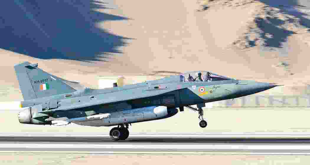 An HAL Tejas fighter aircraft takes off from the runway during a sortie.