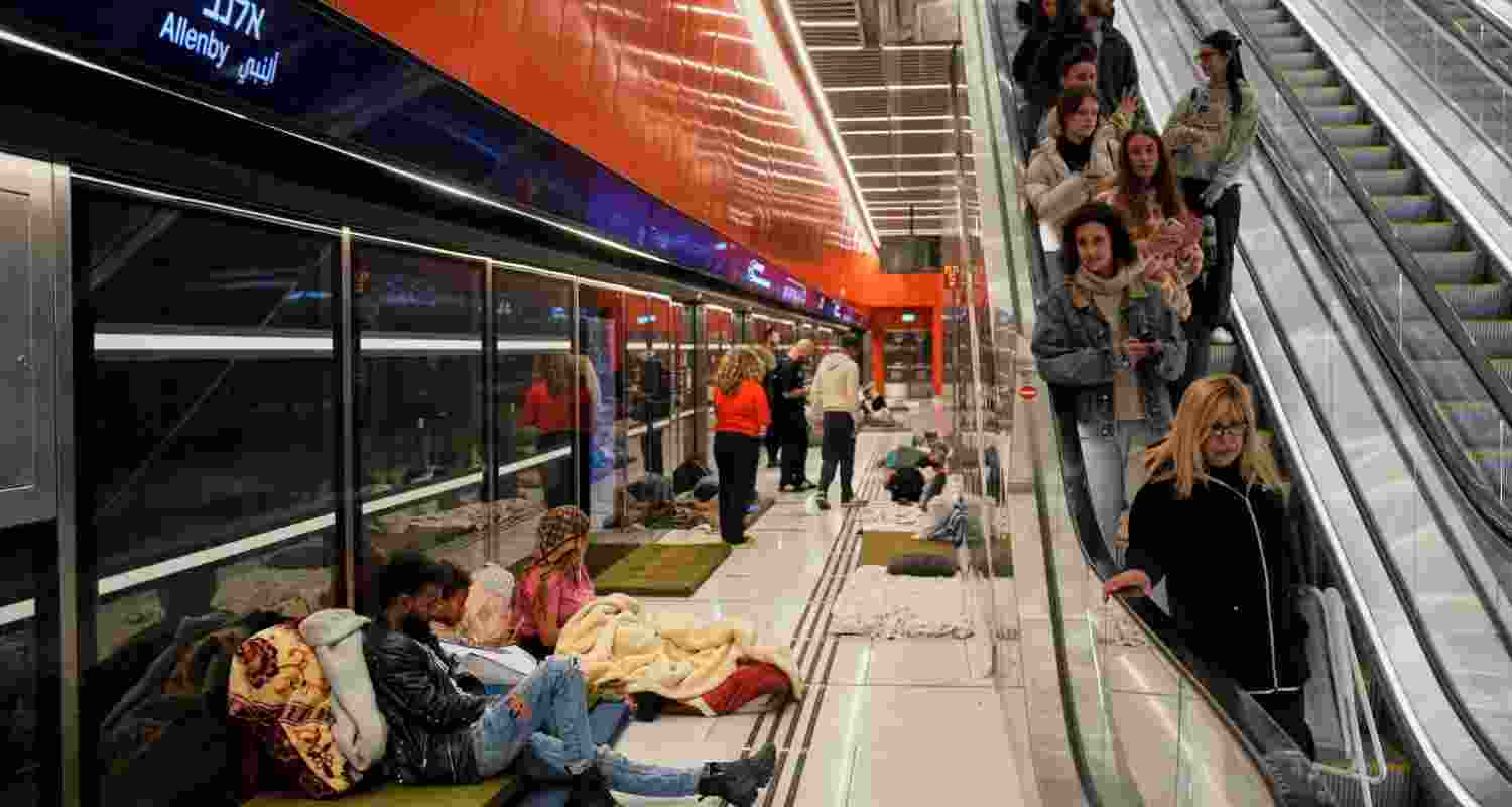 People take shelter in an underground metro station as air raid sirens warn of incoming Iranian missiles in Tel Aviv, Israel, Saturday, March 7, 2026. 