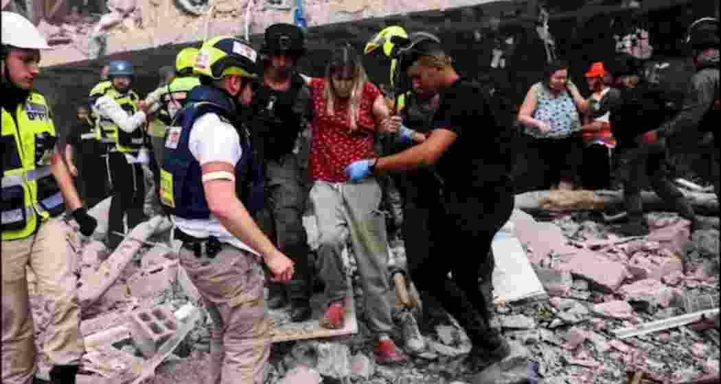 Emergency medical teams attend the site of a direct missile strike in central Israel, following Iran’s retaliatory barrage on Sunday.